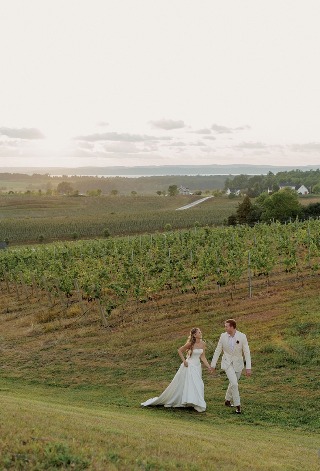 Katie and Logan walking together through the vineyard at Chateau Chantal