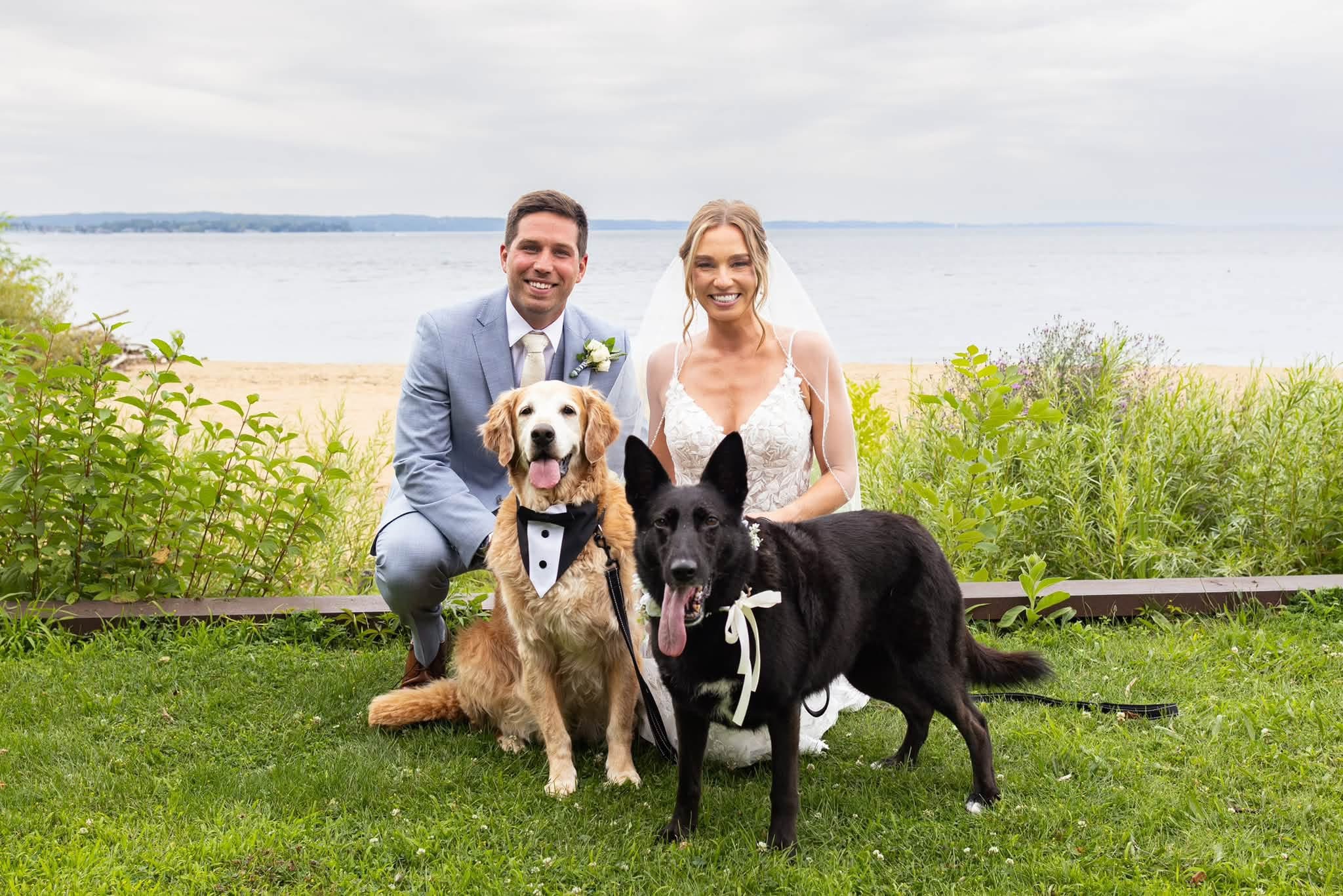 Kristen and Aaron with their golden retriever and Belgian Malinois at the waterfront