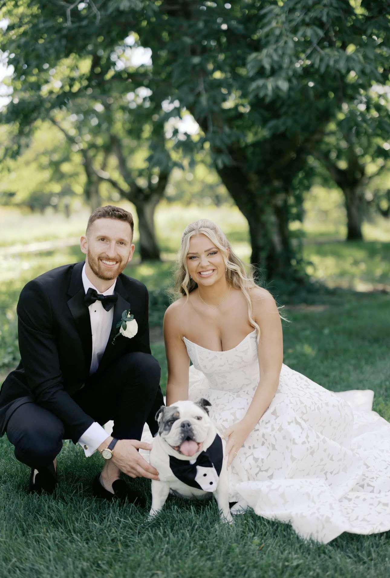 Lauren and Evan with their bulldog on their wedding day at Gallagher Farms